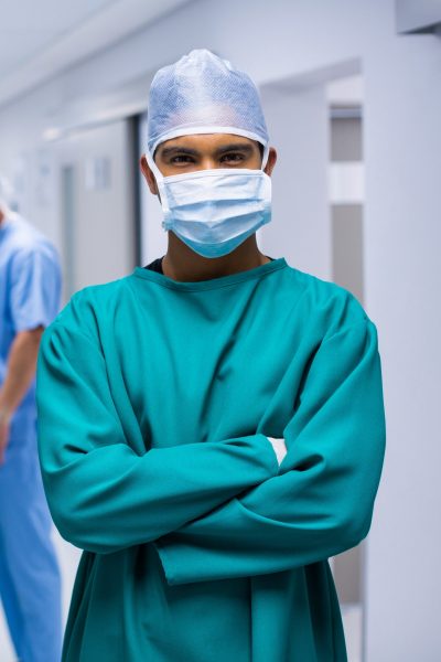 Portrait of surgeon standing in corridor Portrait of surgeon standing in corridor